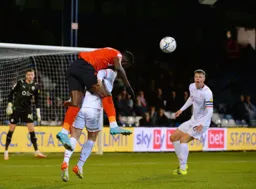 Elijah Adebayo wins an aerial battle with future Hatter Mads Andersen