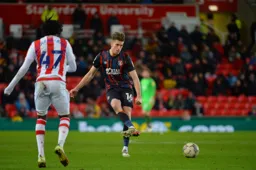 Reece Burke playing a square pass