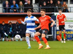 Kal Naismith keeps the ball moving away from Ilias Chair