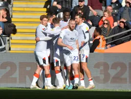 The Luton players celebrate a goal