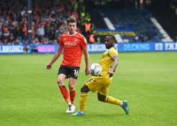 Reece Burke sends the ball back up the line