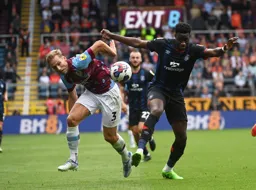 Elijah Adebayo and Charlie Taylor go for the ball