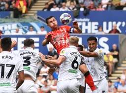 Dan Potts rises above four defenders