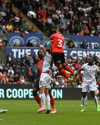Dan Potts rises high for a towering header