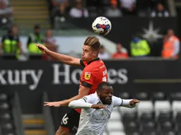 Reece Burke gets above Olivier Ntcham