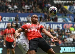 Carlton Morris watches the ball