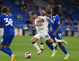 Jordan Clark brushes past Romaine Sawyers