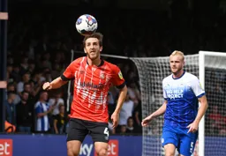 Tom Lockyer watches the ball