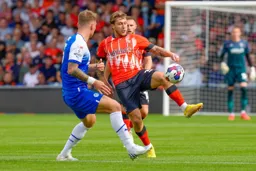 Luke Freeman attempts to lift the ball over Jason Kerr