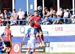 Dan Potts heads the ball on