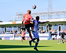 James Bree gets above Harry Pickering to head the ball forward
