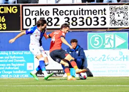 Tom lockyer shields the ball