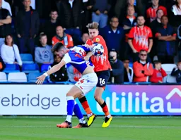 Reece Burke tussles for the ball against George Hurst