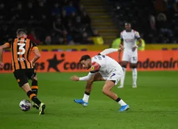 Harry Cornick gets down low as he closes down Callum Elder