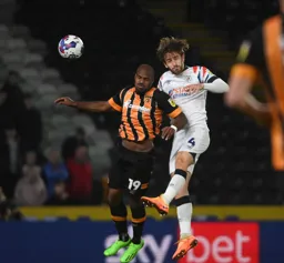 Tom Lockyer heads the ball clear