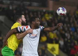 Cameron Jerome and Grant Hanley grab hold of each other