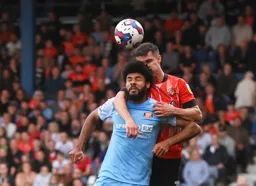Dan Potts and Ellis Simms compete for the ball