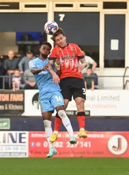 Luke Freeman wins a header against Amad