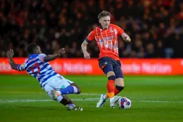 Andy Yiadom moves in to slide tackle Alfie Doughty