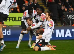 Luke Berry is mobbed by Elijah Adebayo, Pelly Ruddock-Mpanzu and Tom Lockyer after scoring the winner