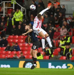 Allan Campbell is outjumped by Dwight Gayle