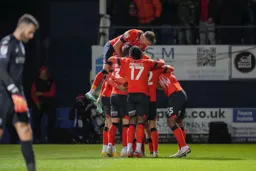 Allan Campbell is mobbed by his team mates after scoring the first goal