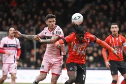 Pelly Ruddock-Mpanzu gets his head to the ball