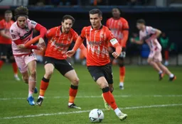 Dan Potts runs the ball out of the penalty area