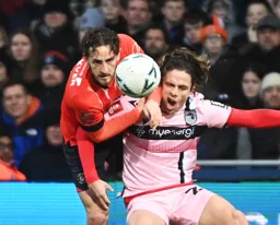 Tom Lockyer climbs over Danilo Orsi-Dadomo to head the ball clear