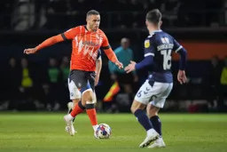 Carlton Morris gives the defender the eyes