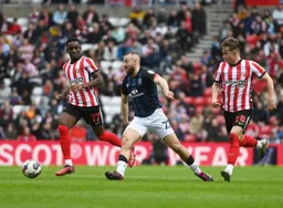 Allan Campbell plays the ball forward