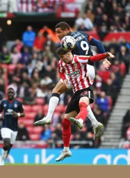 Carlton Morris leaps above Trai Hume