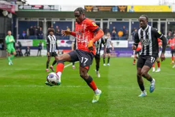 Pelly Ruddock-Mpanzu controls the ball as Ismael Kone closes him down