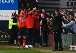 Tom Lockyer celebrates with the fans