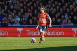 Tom Lockyer plays the ball forward