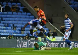 Carlton Morris leaps over the the Reading keeper