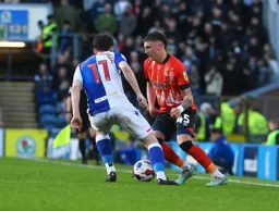 Alfie Doughty looks to nutmeg Joe Rankin-Costello