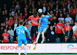 Elijah Adebayo heads the ball on