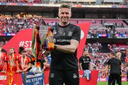 A proud manager poses with the trophy