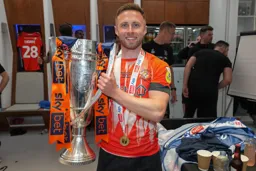 Jordan Clark displays the trophy