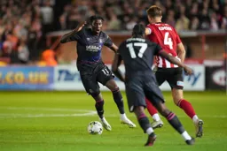 Elijah Adebayo first to the ball