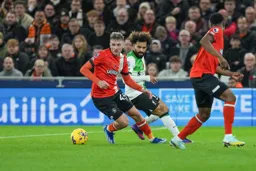 Alfie Doughty shadowed by Mo Salah