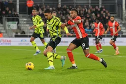 Jacob Brown puts Saliba under pressure