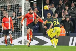 Andros Townsend wins the ball with a high boot
