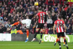 Elijah Adebayo back heads the ball past the Blades defence