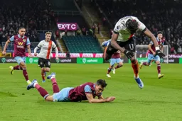Elijah Adebayo flying over the Burnley defender