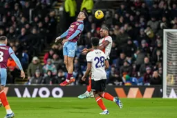 Teden Mengi heads the ball clear