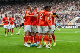 Town celebrating Osho scoring the first goal