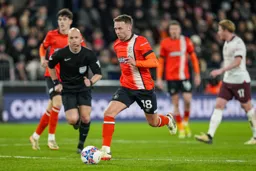 Jordan Clark heads for goal pursued by Referee Anthony Taylor