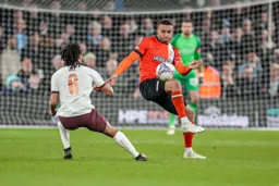 Carlton Morris gets past Ake